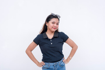 A pretty young asian lady in a dark blue polo shirt and jeans. Isolated on a white background.