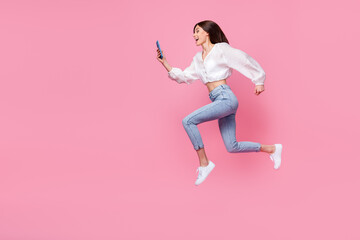 Fototapeta na wymiar Full length photo of positive lady denim stylish outfit hurry up discount device gadget shop empty space isolated pink color background