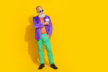 Full size photo of handsome grandpa adjust purple velvet jacket buttonhole wear trendy colorful outfit isolated on yellow color background