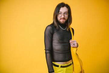 Young, handsome gay man on a colored background in the studio. LGBT concept.