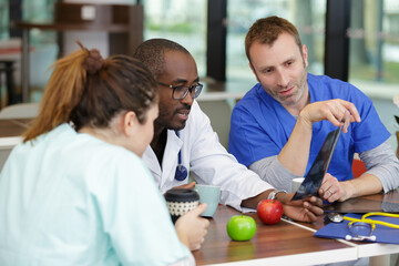 student interns have lunch and use computer