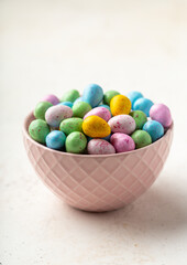 Sweet chocolate eggs in a pink bowl