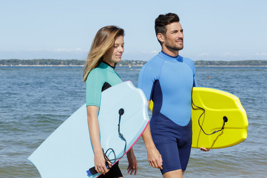 surfers on beach having fun in summer
