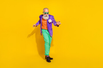 Fototapeta na wymiar Full length photo of positive cheerful guy dressed violet velvet jacket having fun disco isolated yellow color background