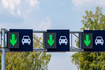 Road signs in lanes, reverse car traffic.