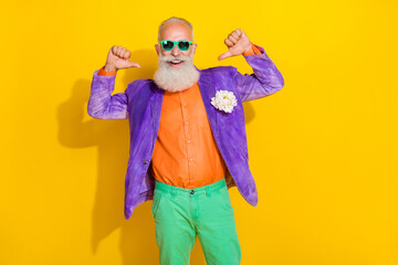 Portrait of cheerful grandfather toothy smile direct thumb fingers himself beard isolated on yellow color background