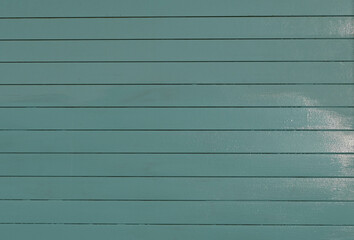 Fondo con detalle y textura de multitud de lamas en tonos turquesa y suave degradado de luz