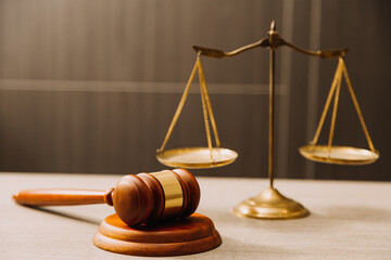 Business and lawyers discussing contract papers with brass scale on desk in office. Law, legal services, advice, justice and law concept