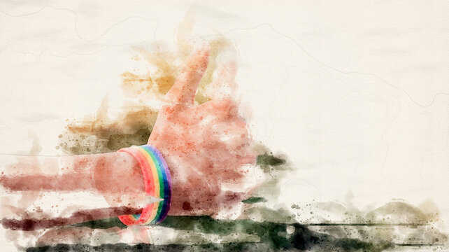 Hand which has rainbow wristband on showing thumb up, soft and selective focus, concept for lgbtq+ gender sign showing                              