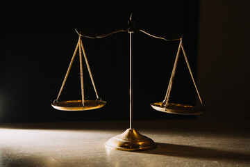 Business and lawyers discussing contract papers with brass scale on desk in office. Law, legal services, advice, justice and law concept picture with film grain effect