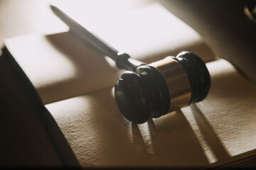 Business and lawyers discussing contract papers with brass scale on desk in office. Law, legal services, advice, justice and law concept