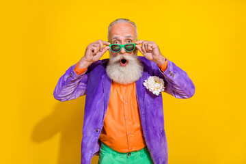 Photo of astonished impressed eccentric man dressed bright fashionable costume wear eyewear open mouth isolated on yellow color background