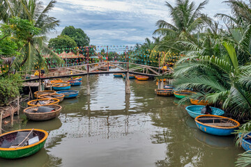 AERIAL VIEW, TOURISTS FROM THAILAND, KOREA, AMERICA AND JAPAN ARE RELAX AND EXPERIENCING A BASKET BOAT TOUR AT THE COCONUT WATER ( MANGROVE PALM ) FOREST IN CAM THANH VILLAGE, HOI AN,QUANG NAM,VIETNAM