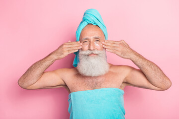 Photo of pensioner retired man touch facial hands apply peeling gel after bath isolated on pastel color background