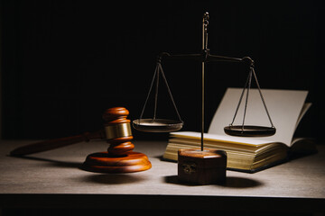 Justice and law concept.Male judge in a courtroom with the gavel, working with, computer and docking keyboard, eyeglasses, on table in morning light