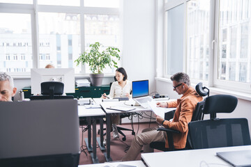Diverse colleagues working in modern coworking space