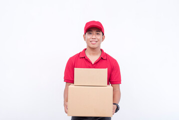 A handsome asian delivery man, carrying two boxes. A courier handling and delivering parcels. Isolated on a white background.