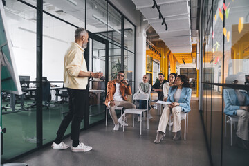 Group of diverse team members attending training at office