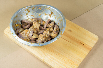 Pork intestine is in a bowl ready to cook mix with herb and oyster sauce,  Pork Chitterlings mix with sauce and garlic.