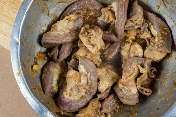 Pork intestine is in a bowl ready to cook mix with herb and oyster sauce,  Pork Chitterlings mix with sauce and garlic.
