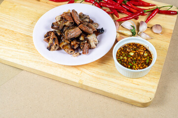 Grilled pork intestine with chilli sauce spicy, Roasted pork Chitterlings with chilli sauce spicy, Local street food of Thai spicy, Carcinogen, Unhealthy food, Cancer.