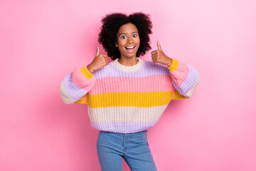 Photo of excited impressed ecstatic girl with perming coiffure dressed knit sweater showing thumbs up isolated on pink color background