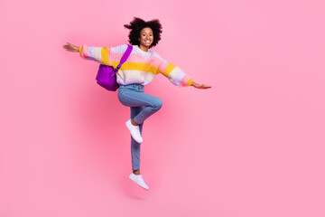 Full length photo of excited funky little child dressed pastel pullover jumping high arms sides...