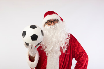 Santa Claus with glasses holding a World Cup soccer ball as a gift for all children, with a white background where his red suit and white beard stand out