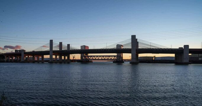 Timelapse clip of the Q bridge at dusk. High quality 4k footage taken on a windy day with a transition from golden light to dusk