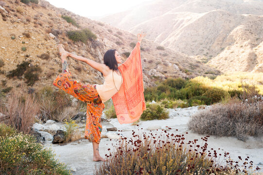 Yoga woman earthing with land and water.