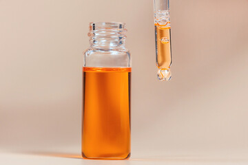Pipette with a glass bottle on a light background.