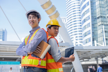 Portrait of two engineer team smiling together at construction site.