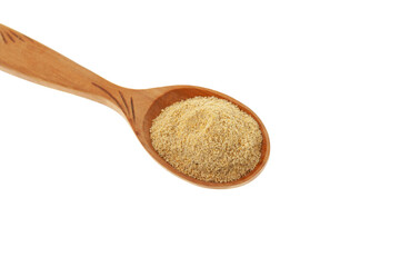Hulbah powder or Fenugreek flour in wooden spoon isolated on white background, close-up, selective focus. Herbal nutritional supplement. Soothe upset stomach and digestive problems