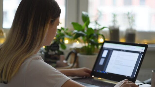 Girl sit down at home office desk table to work remotely, Female business woman scroll web page on using laptop notebook typing keyboard working online. technology distant concept, close up, in winter