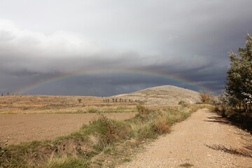 Rainbow after the rain in the mining basins of Teruel, an arid and rural landscape