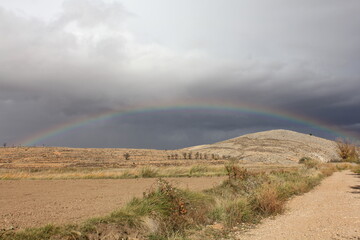 Rainbow after the rain in the mining basins of Teruel, an arid and rural landscape