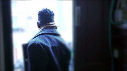 Man leaves home, opens front door, closes the door, and steps outside