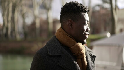 Happy black man walking in nature during winter season smiling and feeling carefree2