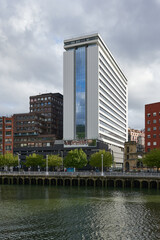 Obraz premium View of the Nevion river and office skyscraper at Bilbao