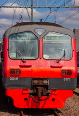 Head wagon of the ED4M electric train on the railway tracks on the station platform.