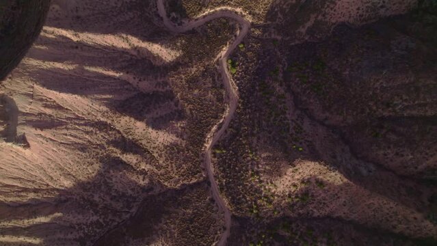 Aerial view of dusty road in desert terrain at sunset. Granada. Andalusia. Spain.