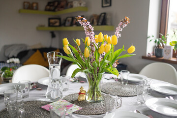 Glass vase with bouquet of beautiful flowers on table in room. Space for text