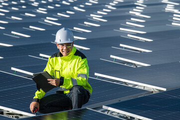 Asian engineer working at Floating solar power plant,Renewable energy,Technician and investor solar panels checking the panels at solar energy installation