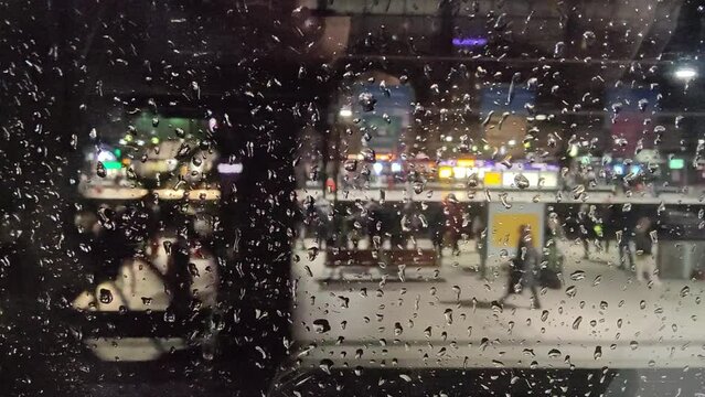Train leaving the Hamburg main station. Focus on the wet window.