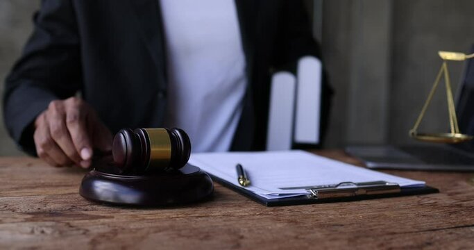 Slow motion video footage of judge giving verdict by hitting mallet at desk, justice and law judge gavel and soundboard Law concept.