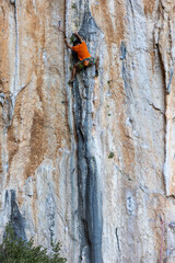 Extreme sport, man, rock climber climbs a difficult route.