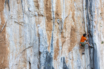 rock climber climbs the route.