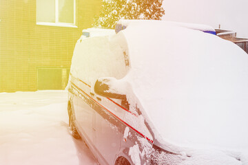 soft focus. natural light. the car is under a large layer of snow. the abundance of precipitation.