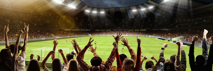 Back view of group of people, football soccer fans cheering at crowded football stadium at evening time. Concept of sport, cup, world, team, event, competition - obrazy, fototapety, plakaty