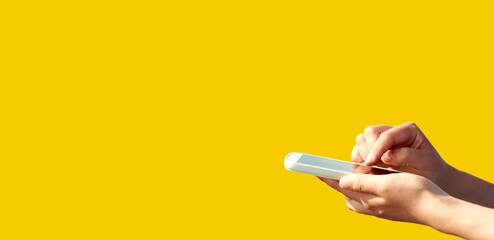 Person using a smartphone on a simple colored background